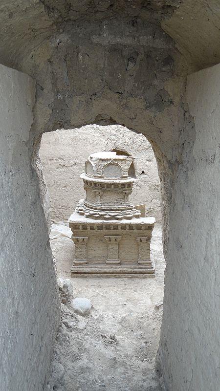 D. View in a chapel with a small stone stupa (around 6th century CE).(© Anna Filigenzi) The round two-story superstructure sits on a wreath of lotus petals. 
